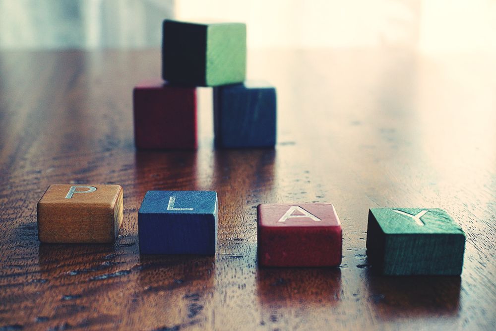 Conceptual Photo of Word "play" Spelled by wooden Blocks.